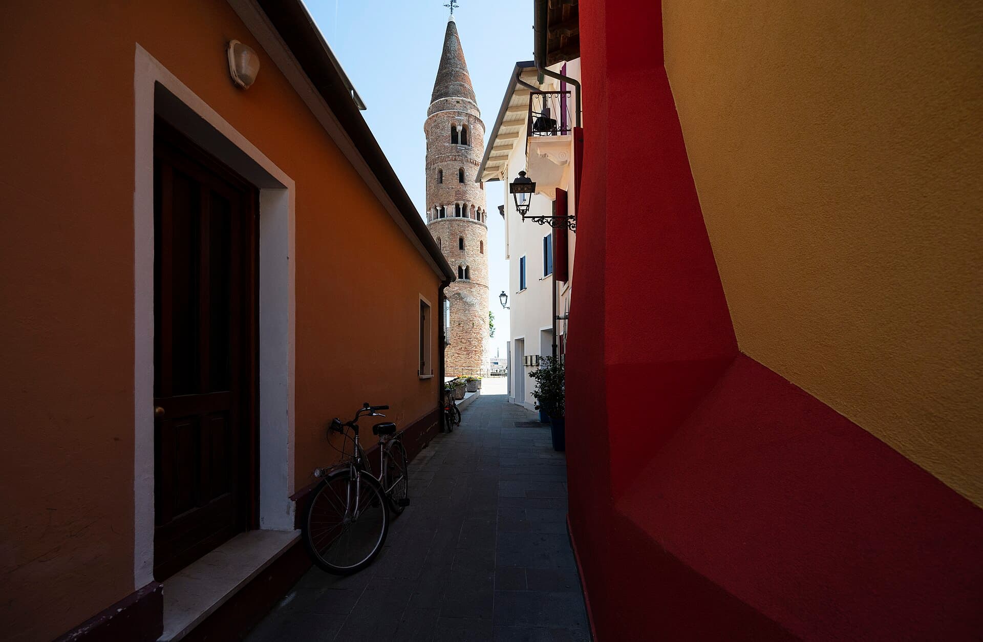 Il campanile cilindrico del Duomo di Caorle tra i vicoli colorati
