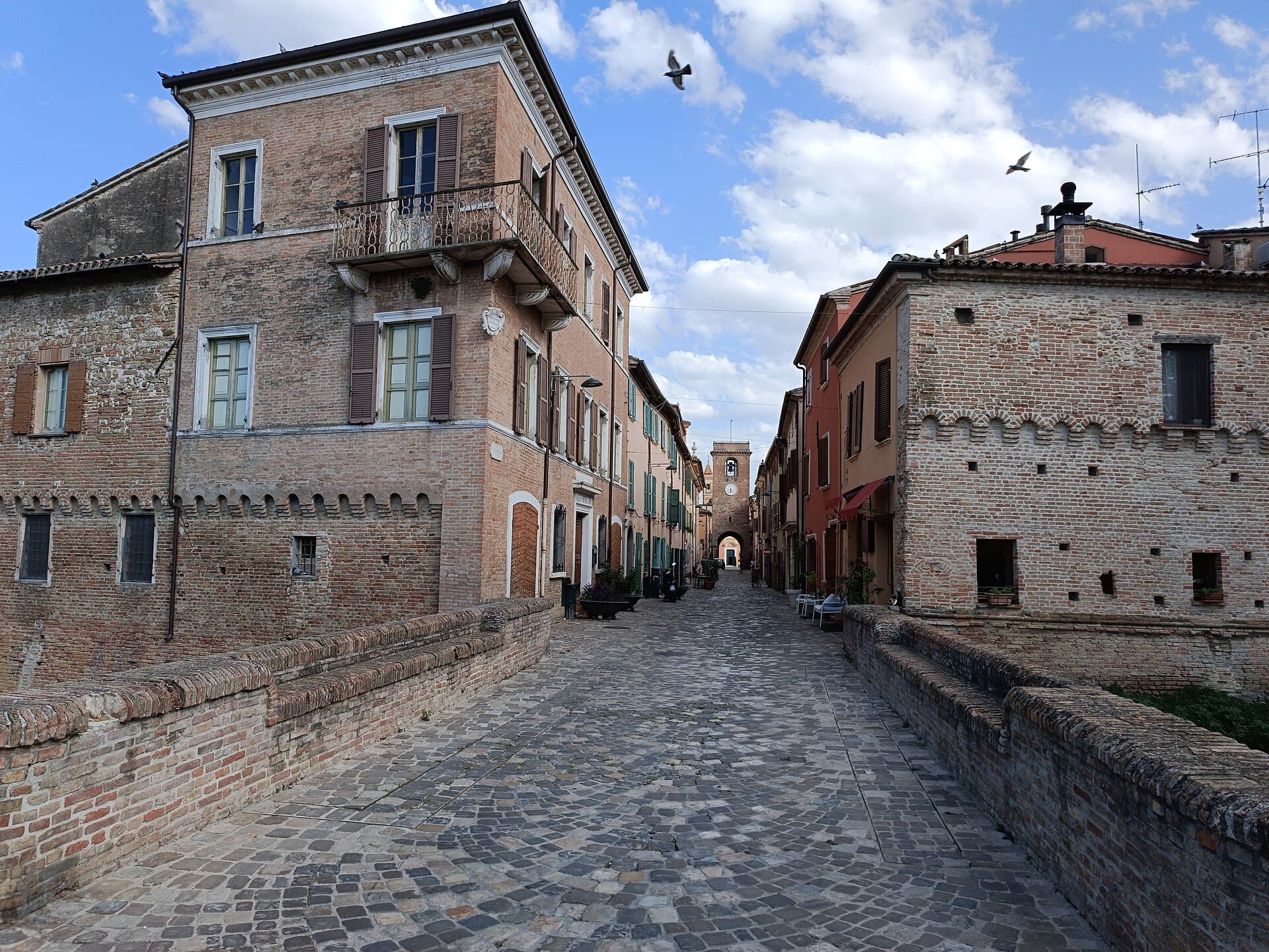 La via acciottolata del centro storico di San Giovanni in Marignano verso la torre civica